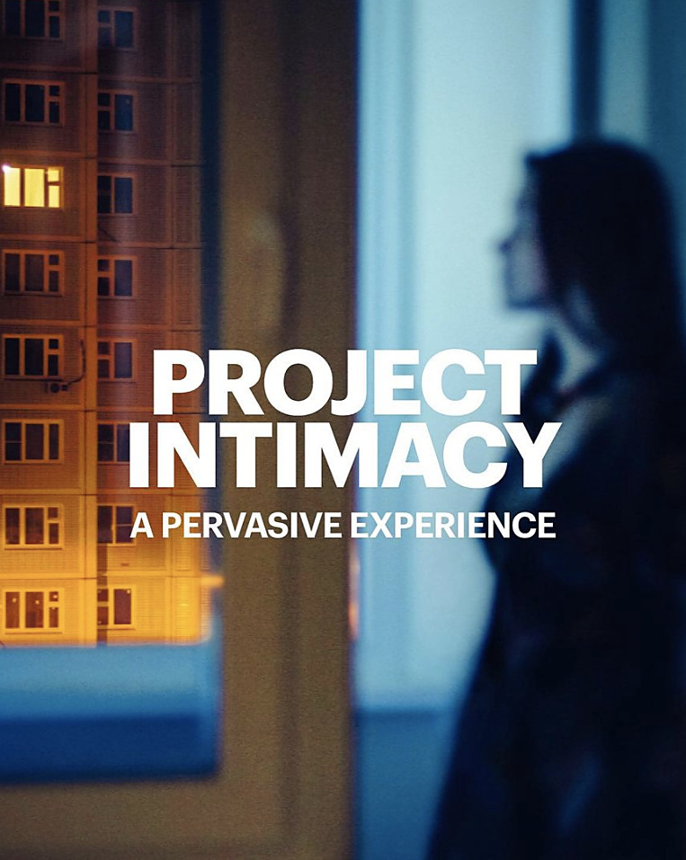 Project Intimacy, a pervasive experience: a woman at a window at night, a lit tower block opposite