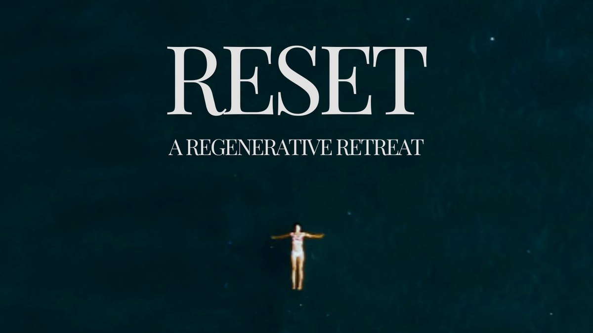 Reset, a regenerative retreat: a swimmer floating in dark water, seen from above