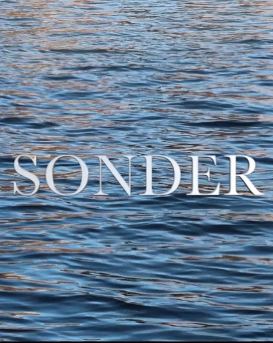 Sonder, written over moving water